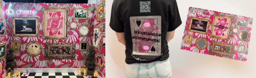 Pink Cherre event display with decorative frames, shown alongside a person in a Cherre card-themed shirt and a matching printed design.